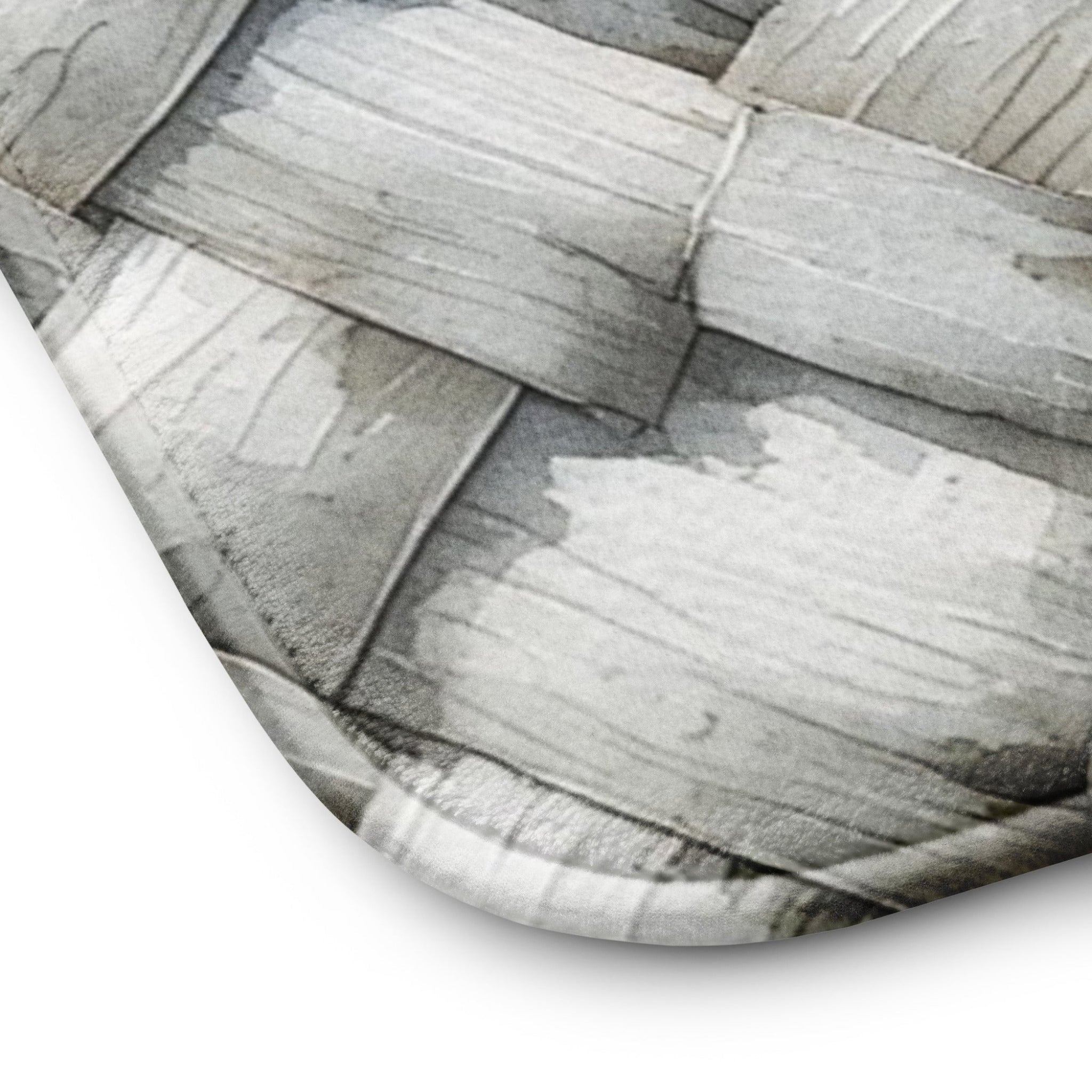 Close-up of Memory foam bath mat with a photorealistic grey and white herringbone woven texture print for a modern bathroom.
