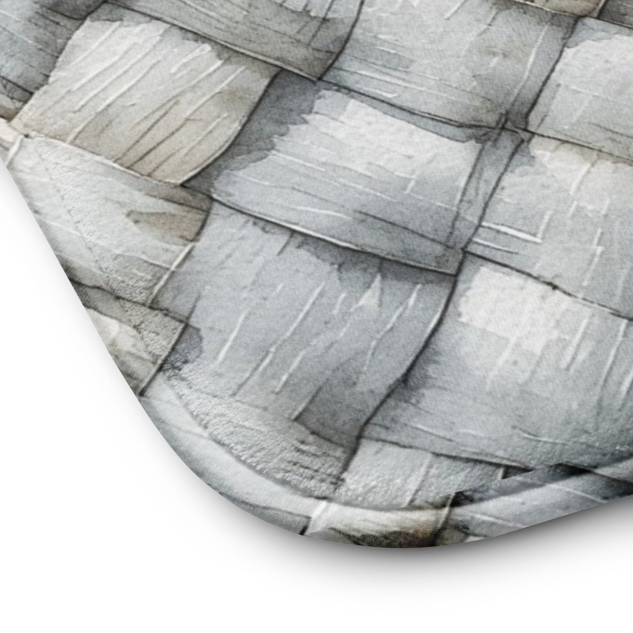 Close- up of Memory foam bath mat with a photorealistic grey and white herringbone woven texture print for a modern bathroom.