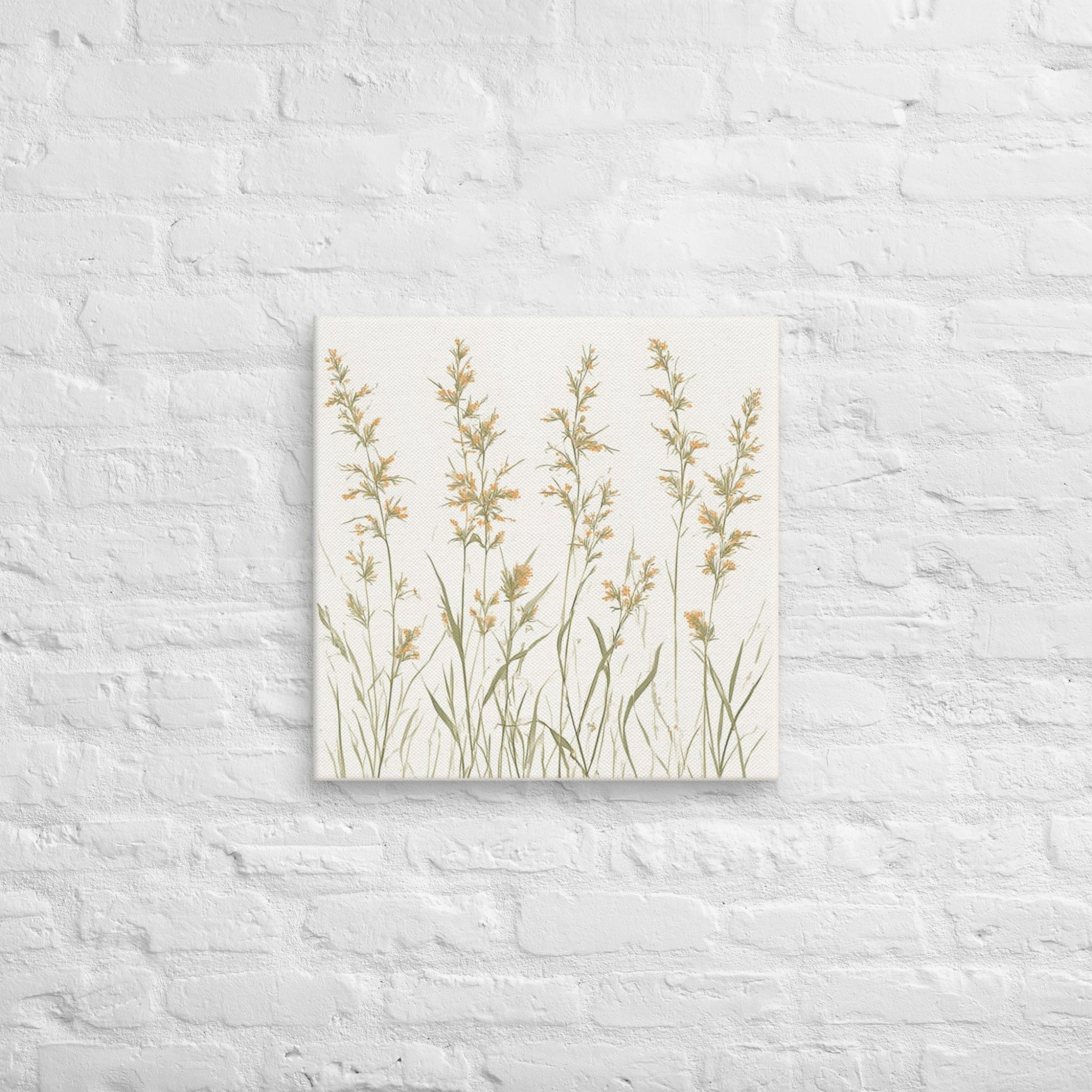 A square canvas print featuring minimalist illustrations of delicate, neutral-toned meadow grasses and wildflower stems on a cream background on a textured white wall