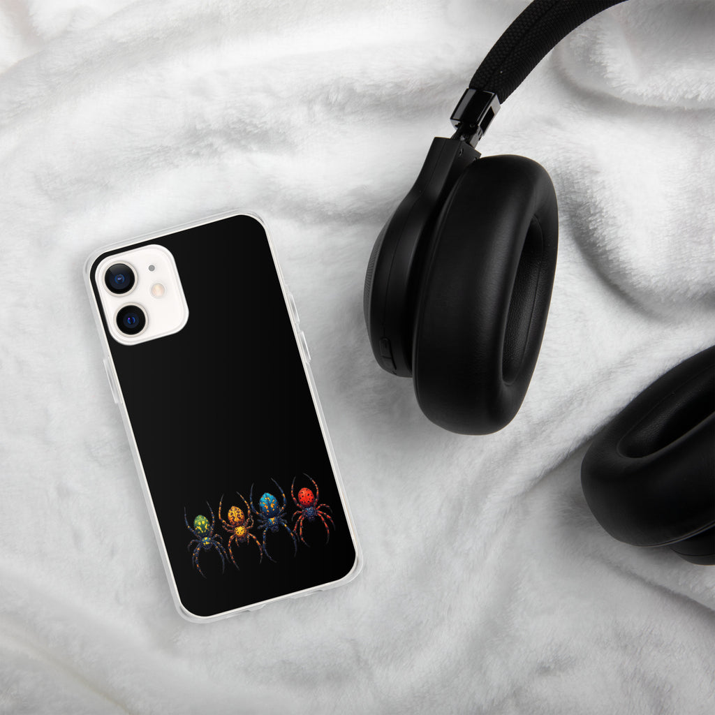 Iphone case with a color spider design laying on a white towel next to black headphones.
