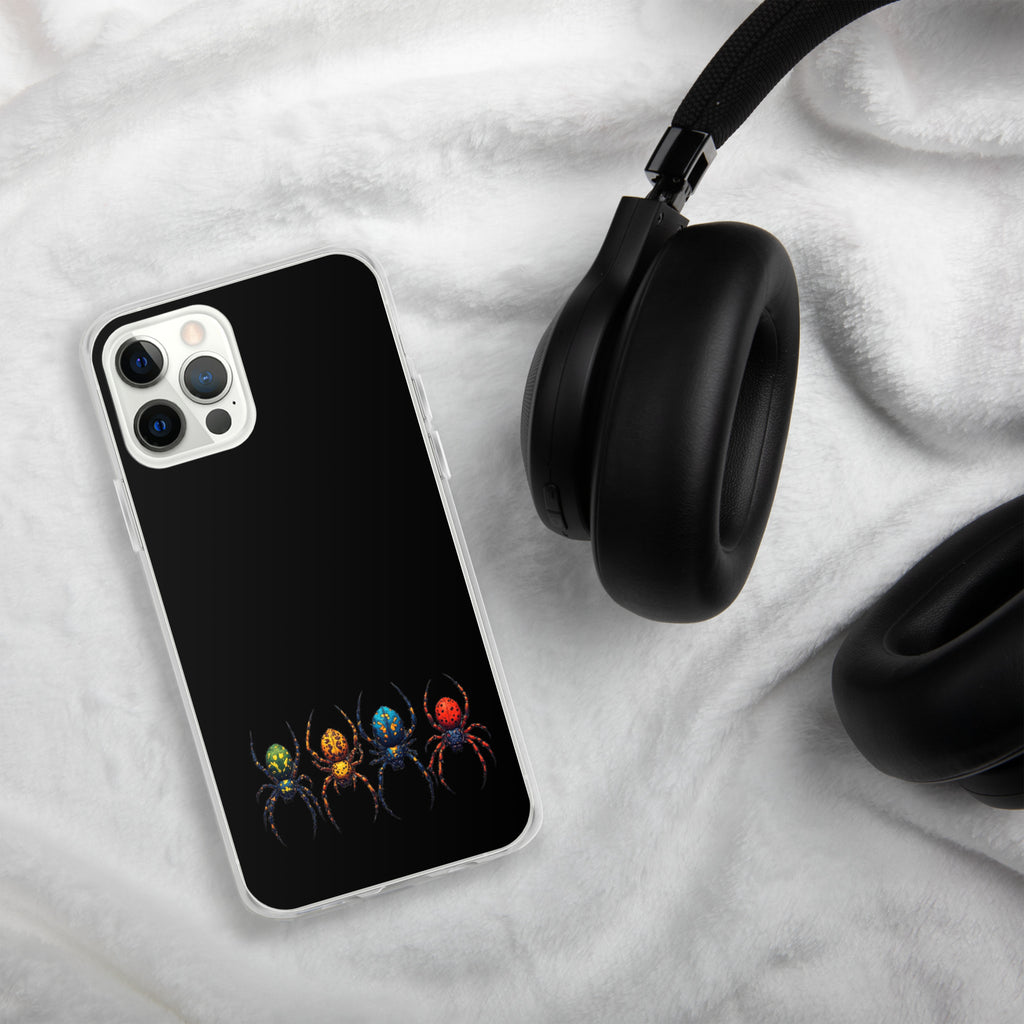 A black phone case with a colorful spider graphic, shown on a white plush blanket next to black headphones.