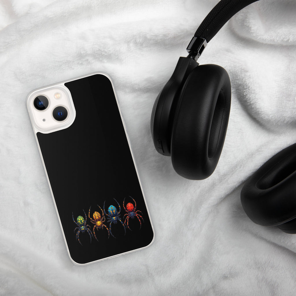 A black phone case with a graphic of four colorful spiders in green, orange, blue, and red, shown on a white plush blanket next to black headphones.