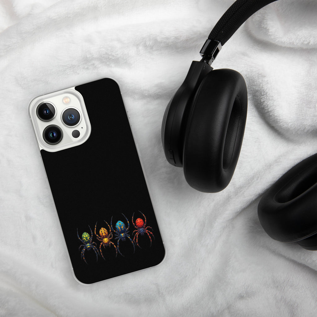 A black phone case featuring a colorful graphic of four stylized spiders in green, orange, blue, and red, shown on a white textured blanket next to black headphones.