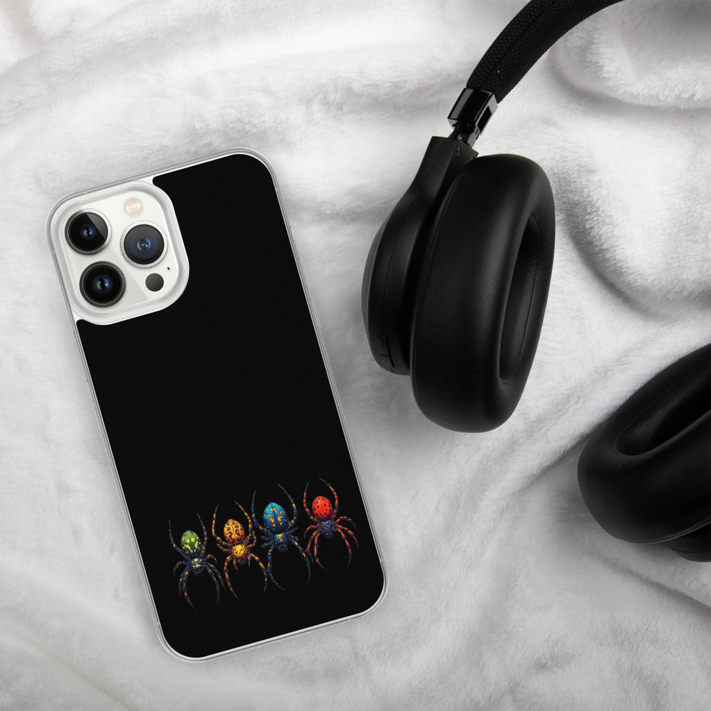 A black phone case with a colorful spider graphic, shown on a white textured blanket next to black headphones.