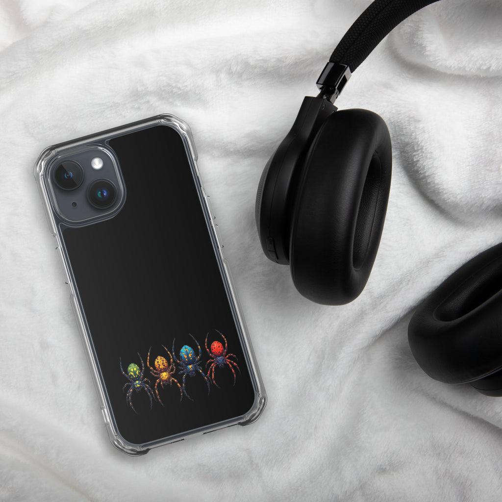 Phone case with colorful spider design on a marble surface with headphones.