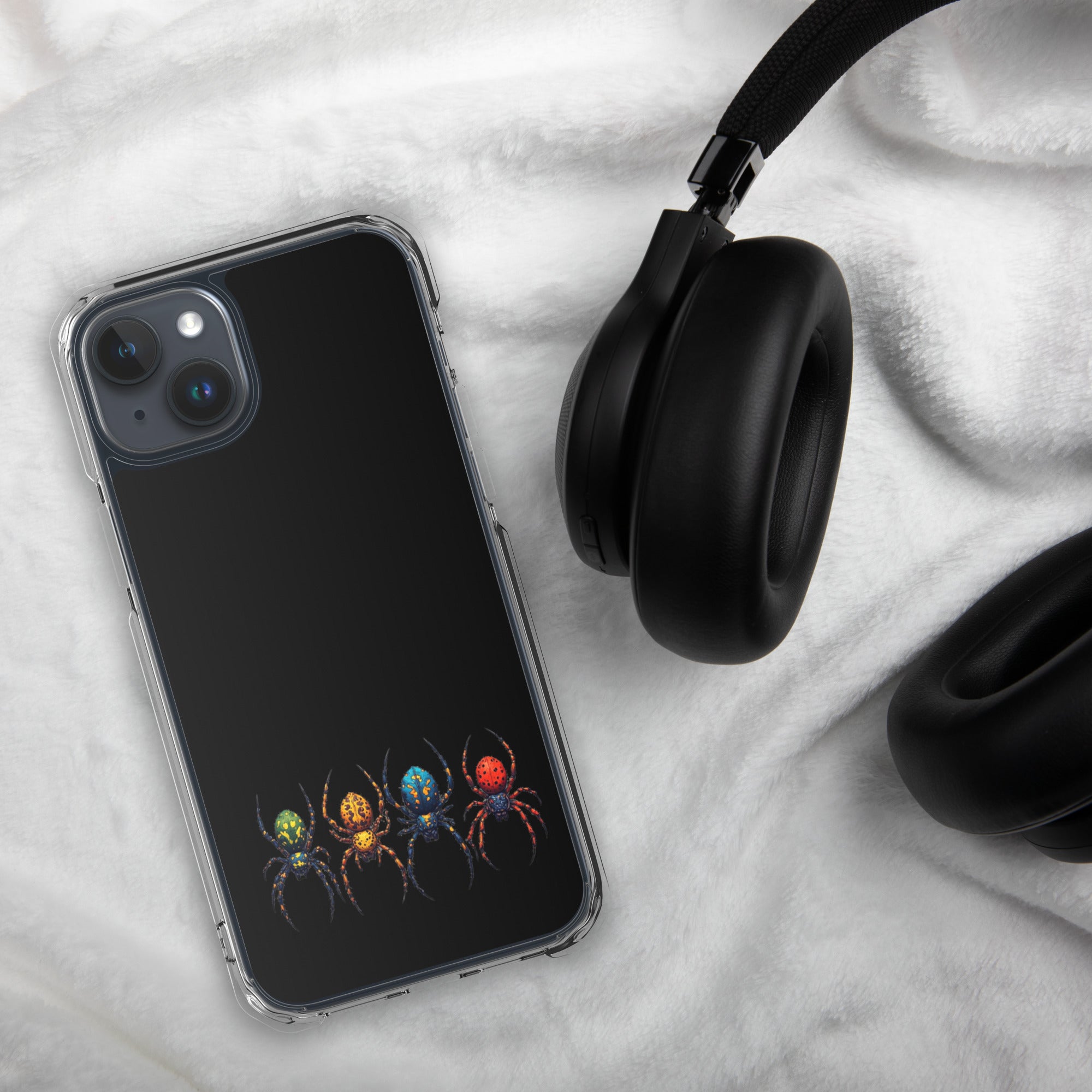 Phone case with black and gray checkered pattern next to black headphones on a white marble surface