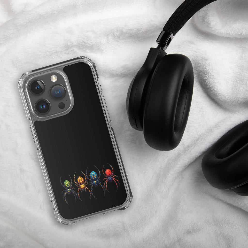 Iphone case with a color spider design laying on white textured background next to a pair of black headphones.