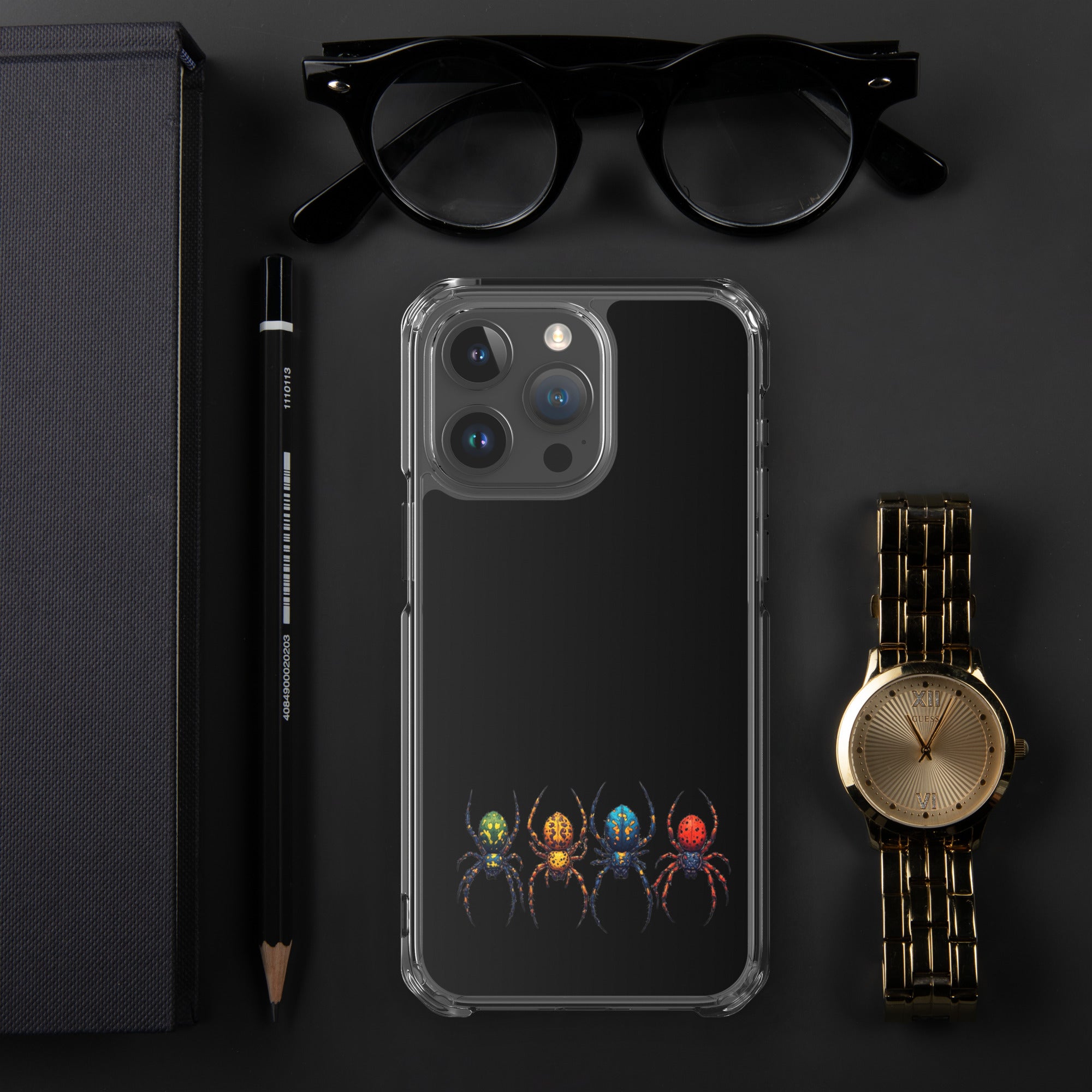 Iphone case with a color spider design laying on black desk with a pen, watch, an eye glasses laying next to the Iphone.