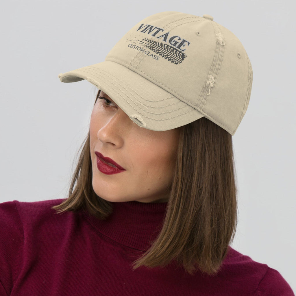 Woman wearing a beige cap with "Vintage Custom Class' text and a maroon long-sleeve shirt on a light gray background. 