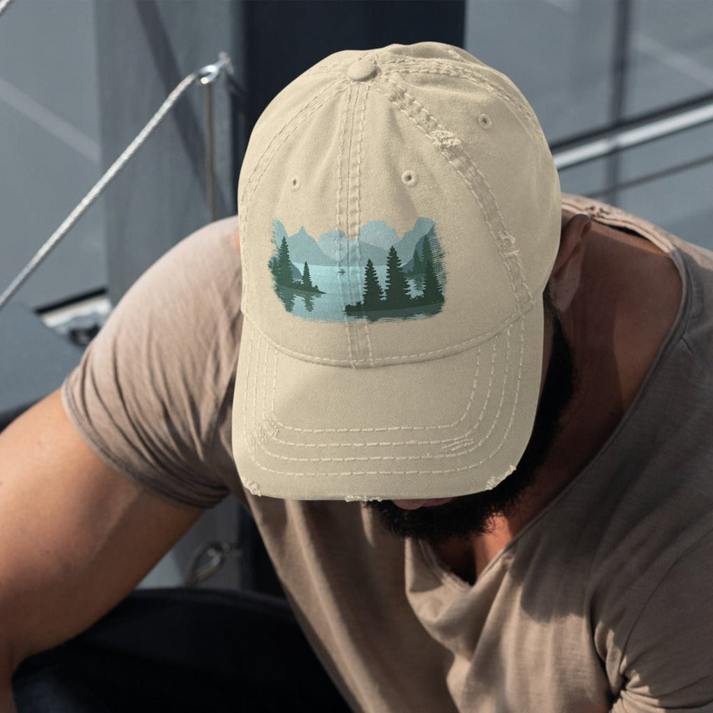 
Man wearing a light beige distressed dad hat with a fisherman lake scene graphic while out on a boat, casual outdoor fishing cap for men.