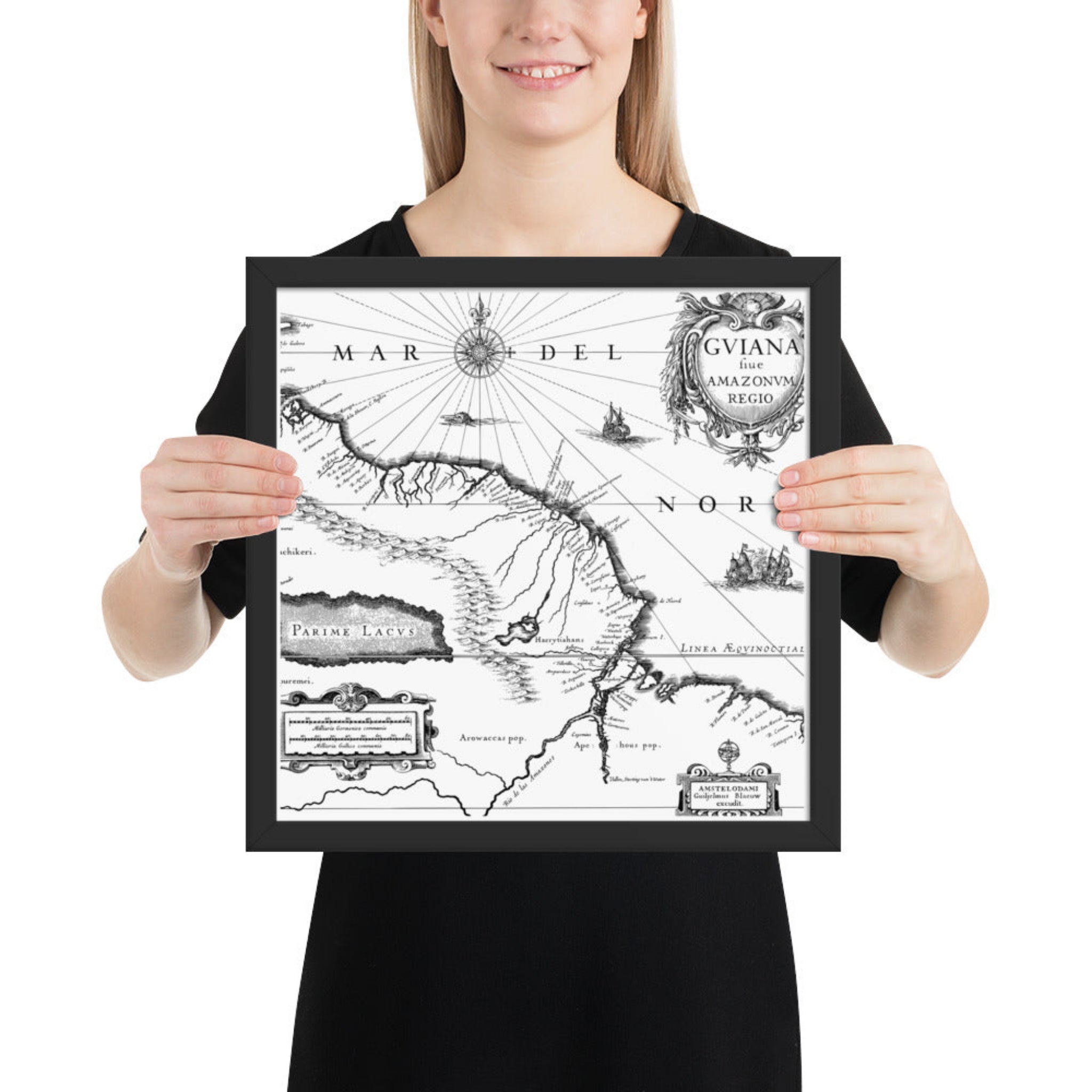 Person holding a framed vintage map of South America