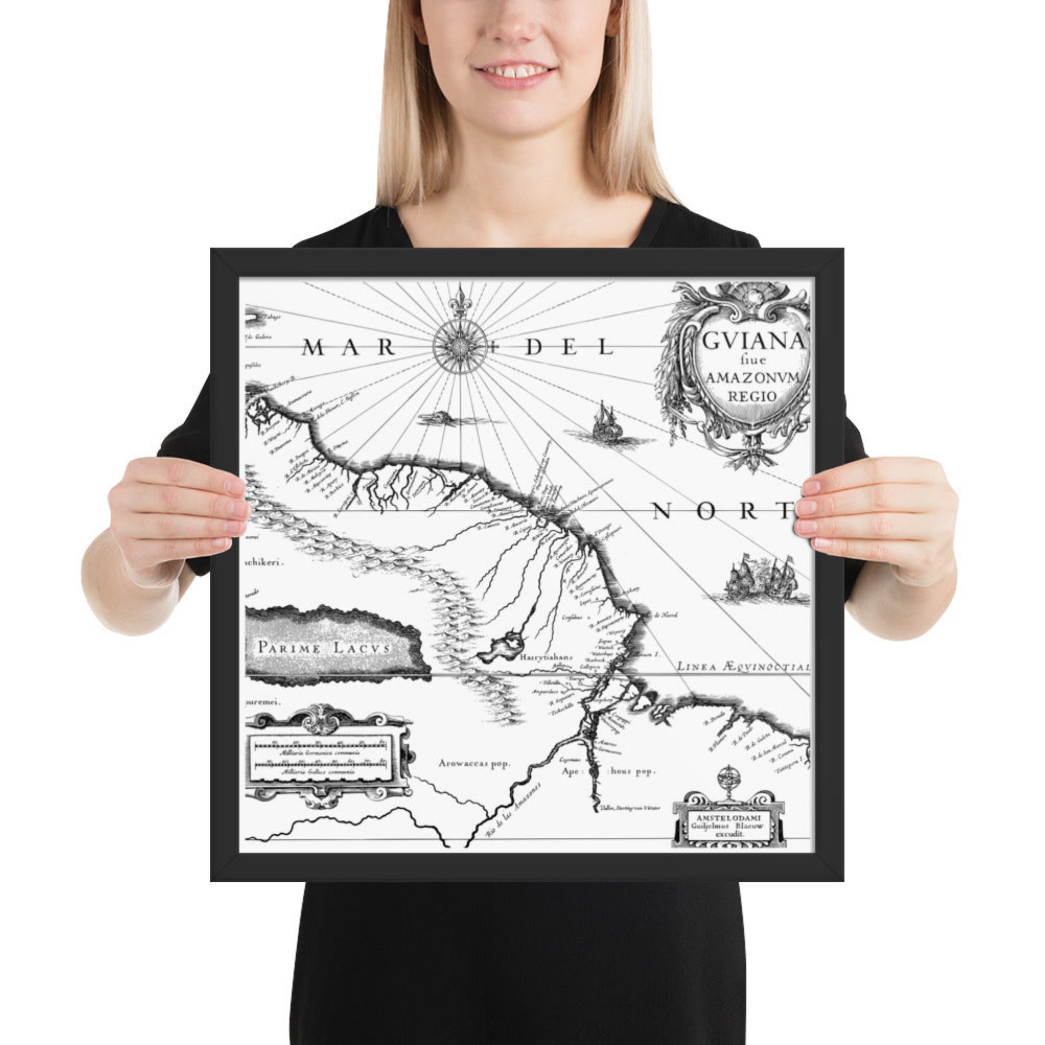 Person holding a framed vintage map of South America