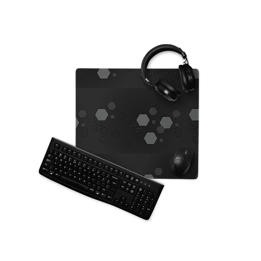 Gaming setup with keyboard, mouse, and headset on a dark-themed mouse pad.