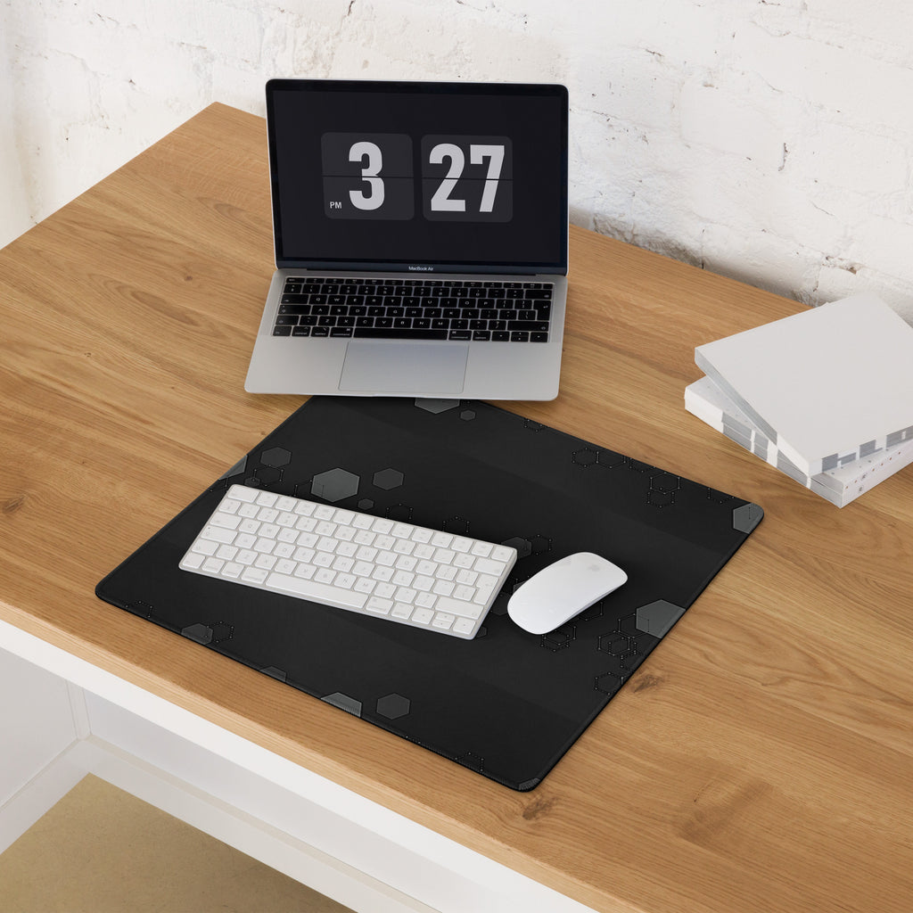 Laptop on a wooden desk with a black Hexagon Geometric Design on Gaming Desk Mat, keyboard, and mouse.