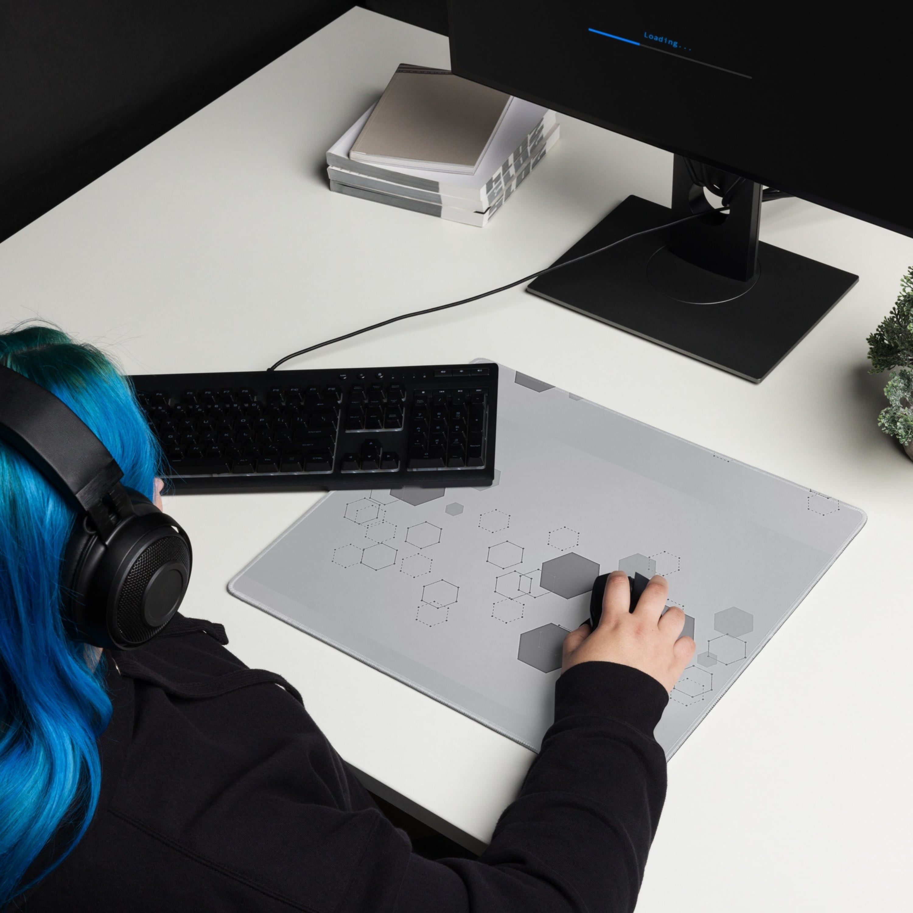 Square gray gamer mouse pad with hexagonal pattern on a white background. 
