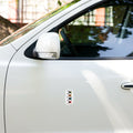 White car with a colorful sticker on the side.