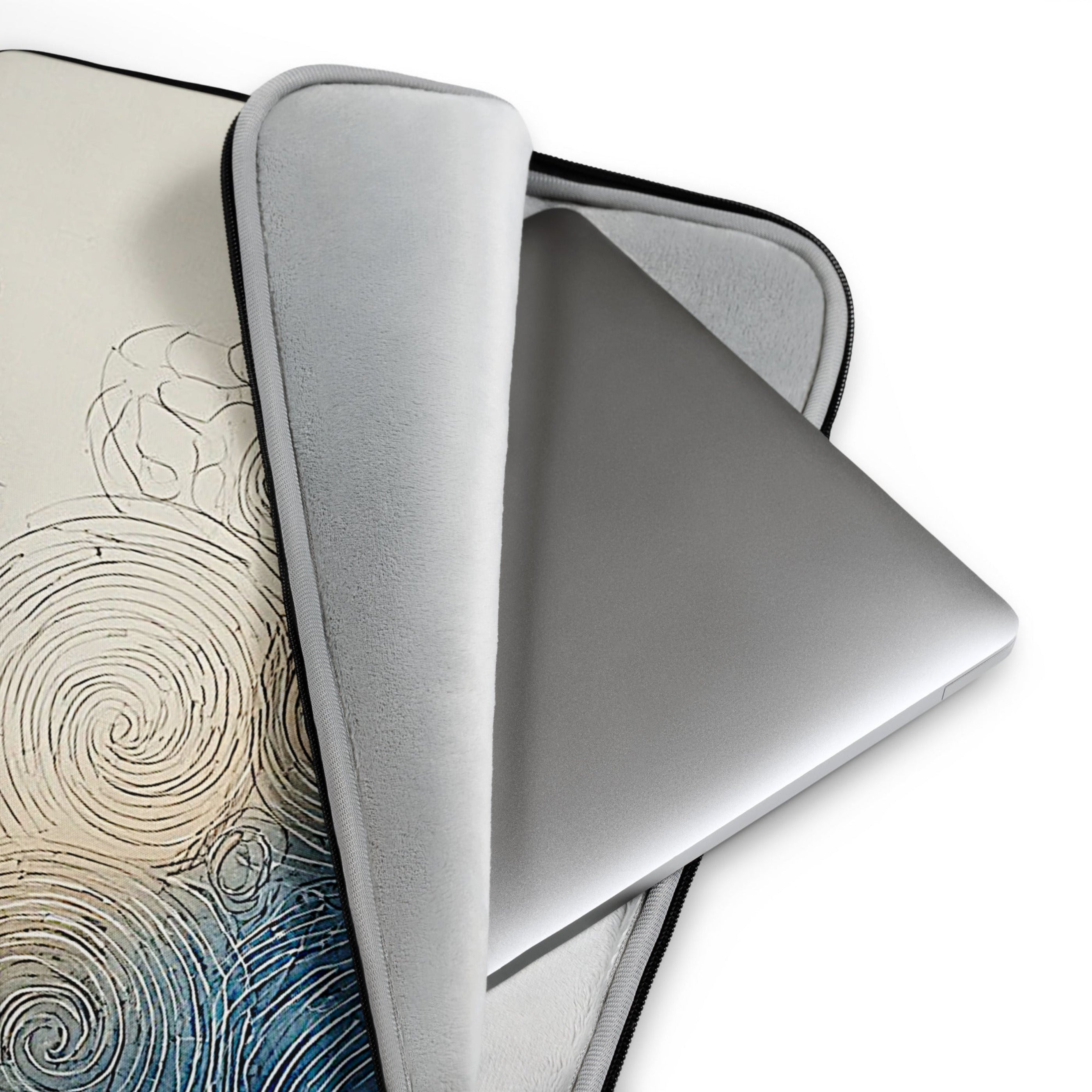 A light gray protective sleeve for a laptop, shown partially open to reveal its interior. A silver laptop is placed inside, and the sleeve is draped over a patterned surface featuring a swirl design in beige and blue tones.