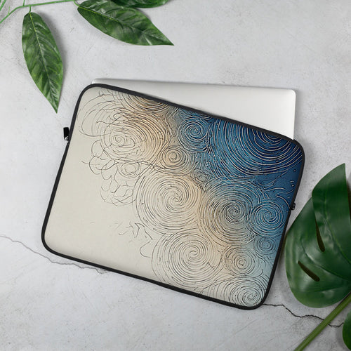 A laptop sleeve with an abstract spiral pattern in blue, beige, and black, shown on a light gray textured surface with green leaves around it.
