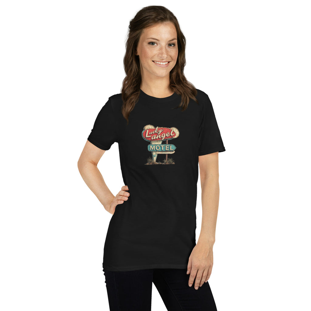 Woman wearing a black t-shirt with a vintage motel sign design on a white background.