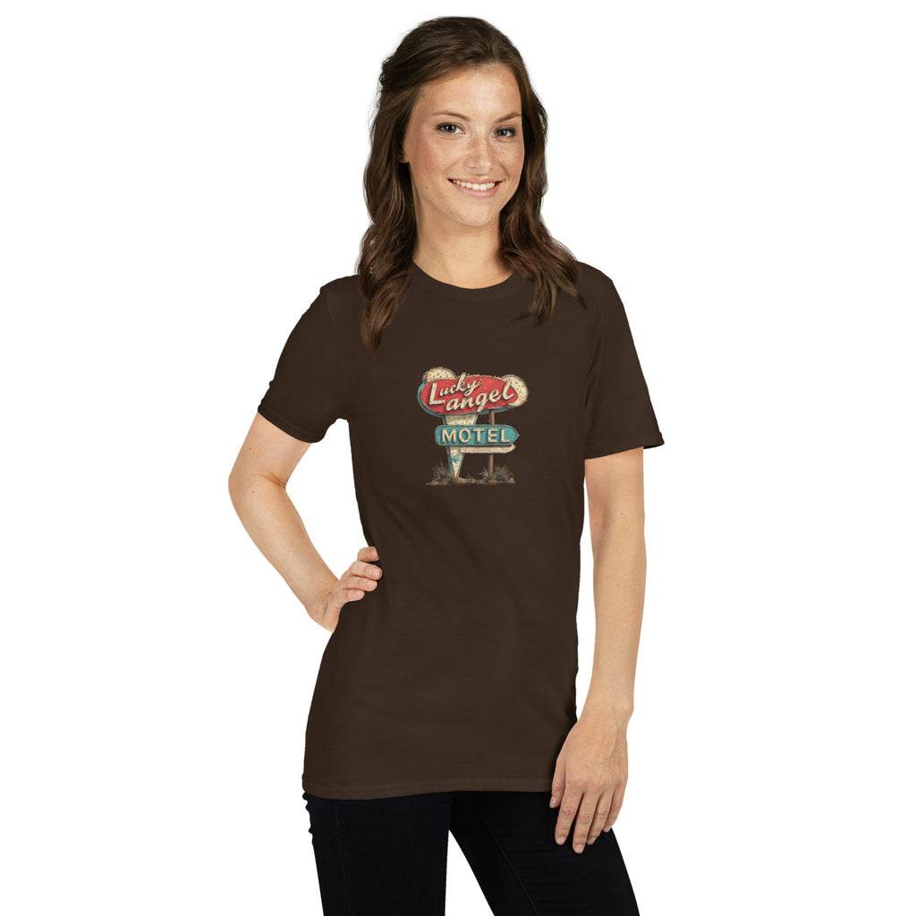 Woman wearing a brown t-shirt with a vintage motel sign design on a white background.