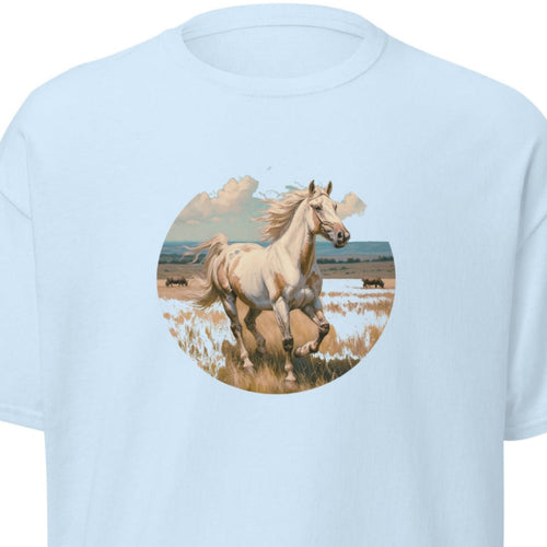 Close-up of a graphic t-shirt featuring a majestic American Paint Horse galloping across a sun-drenched open prairie in a circular nature landscape design.