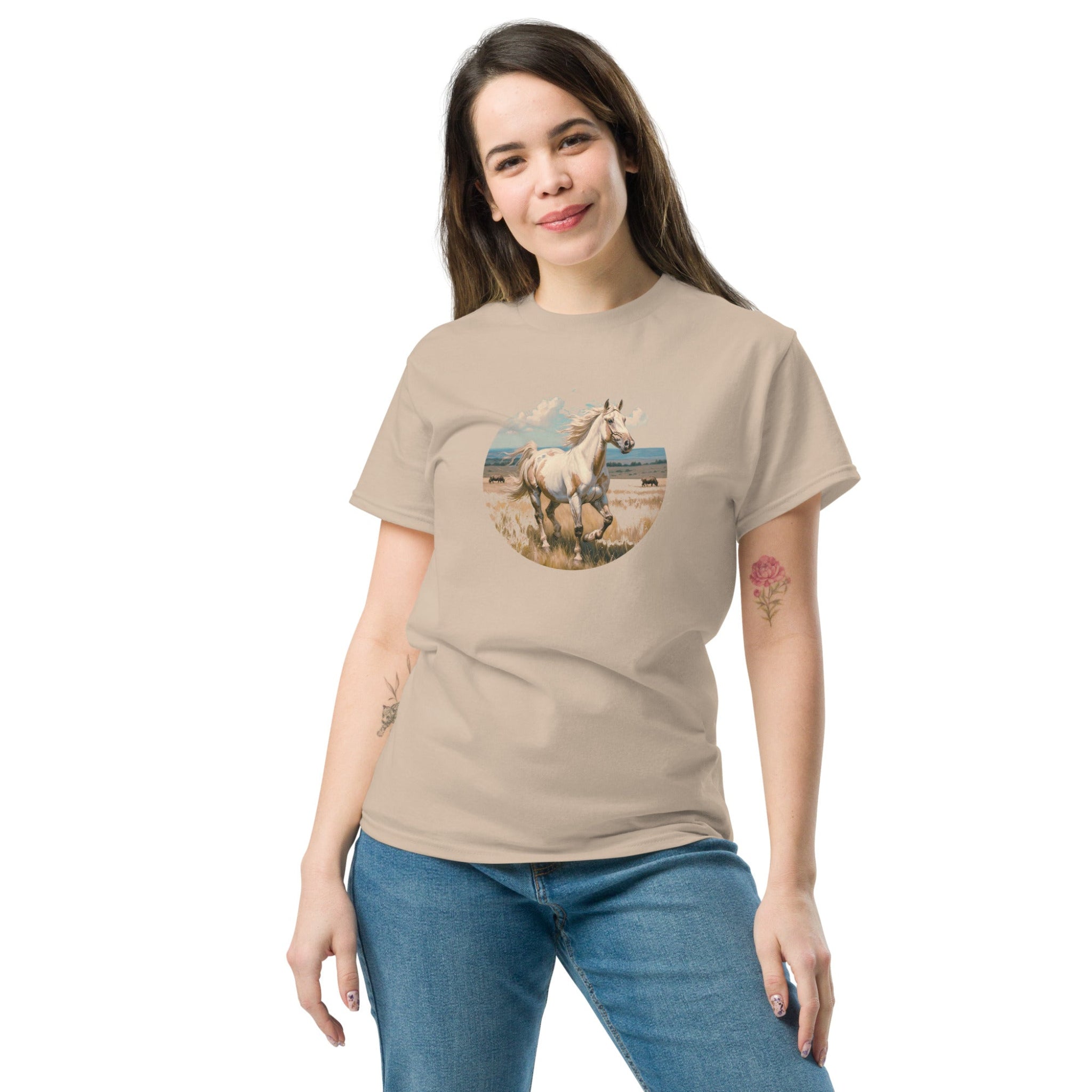 A person wearing a tan t-shirt with a vintage-style illustration of an American Paint Horse running free, perfect for Western and equestrian fashion.