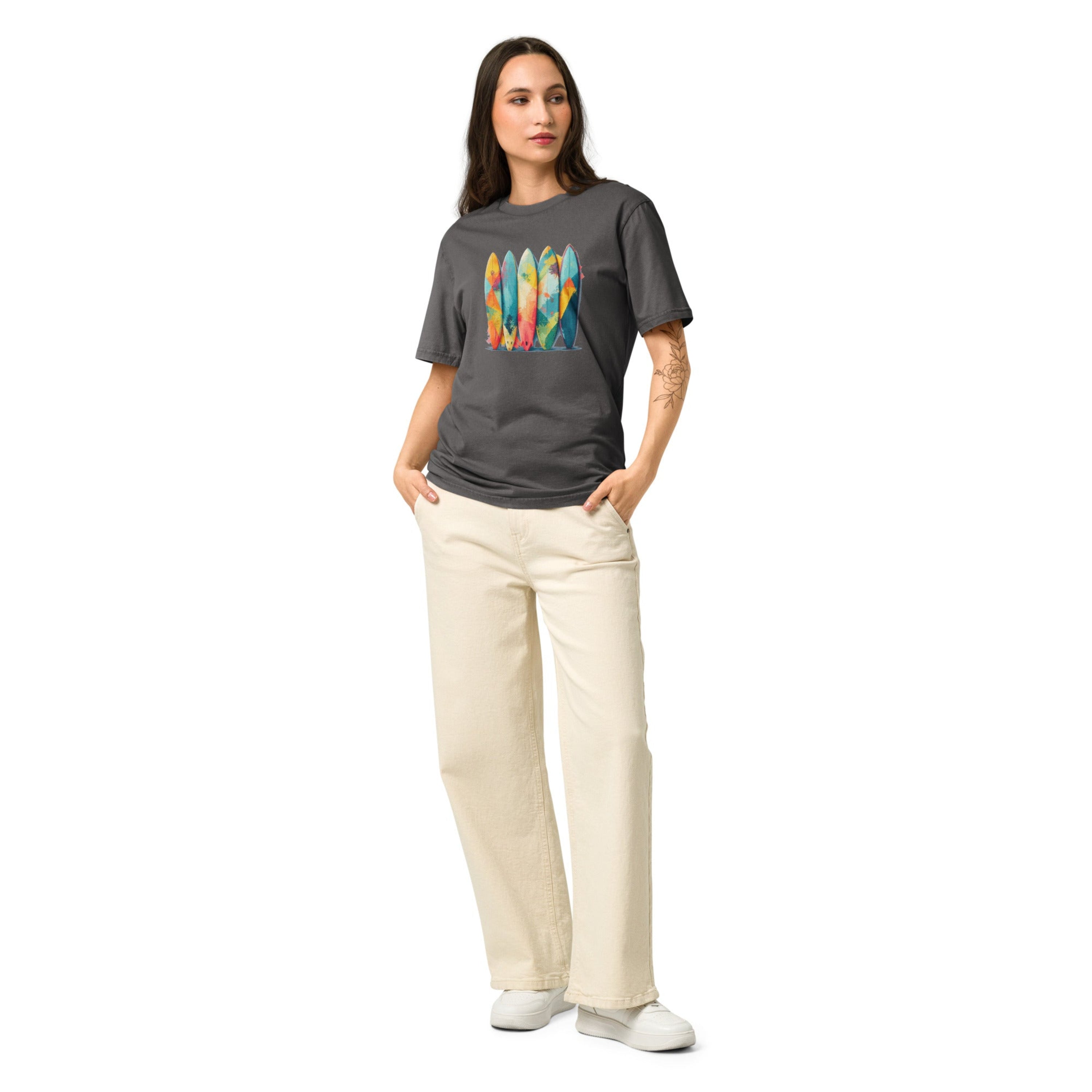Woman wearing a gray t-shirt with a graphic design on a white background.