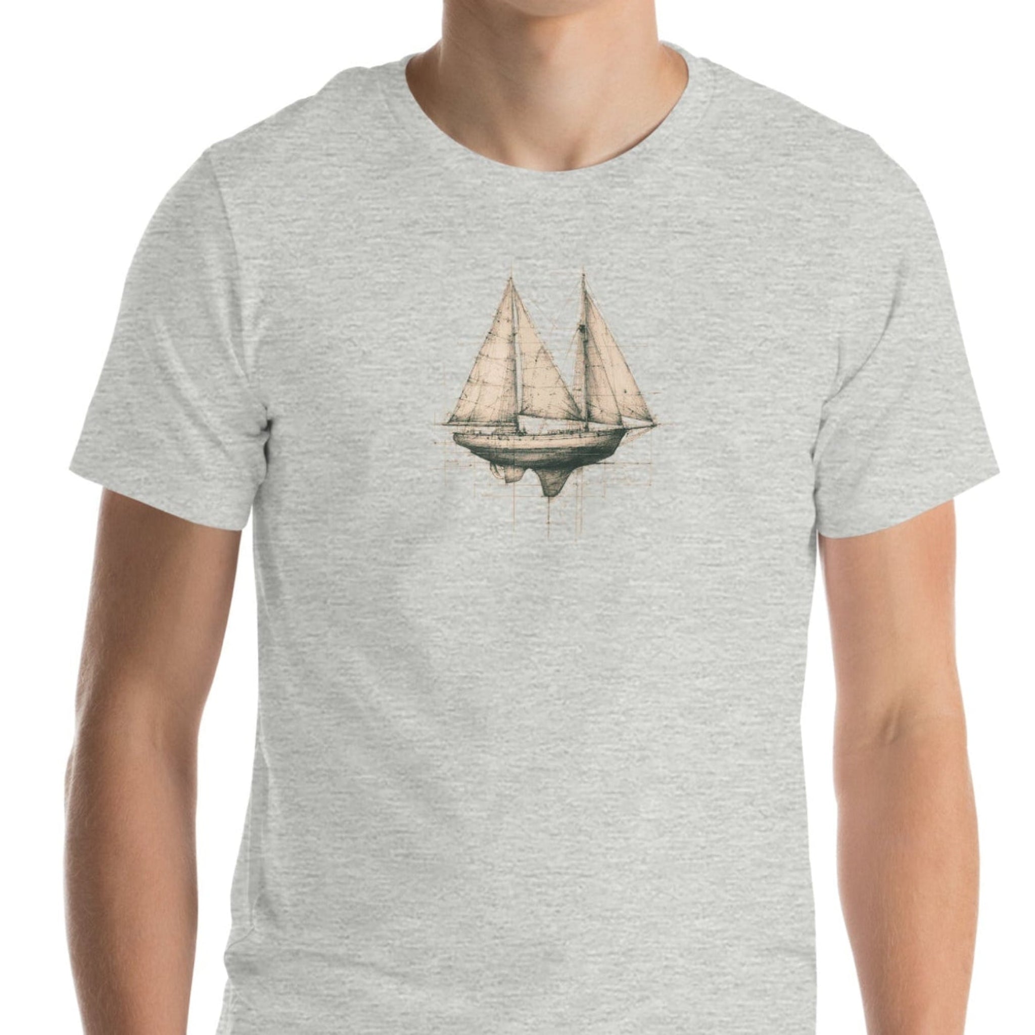 Man wearing gray t-shirt with sailboat design. 