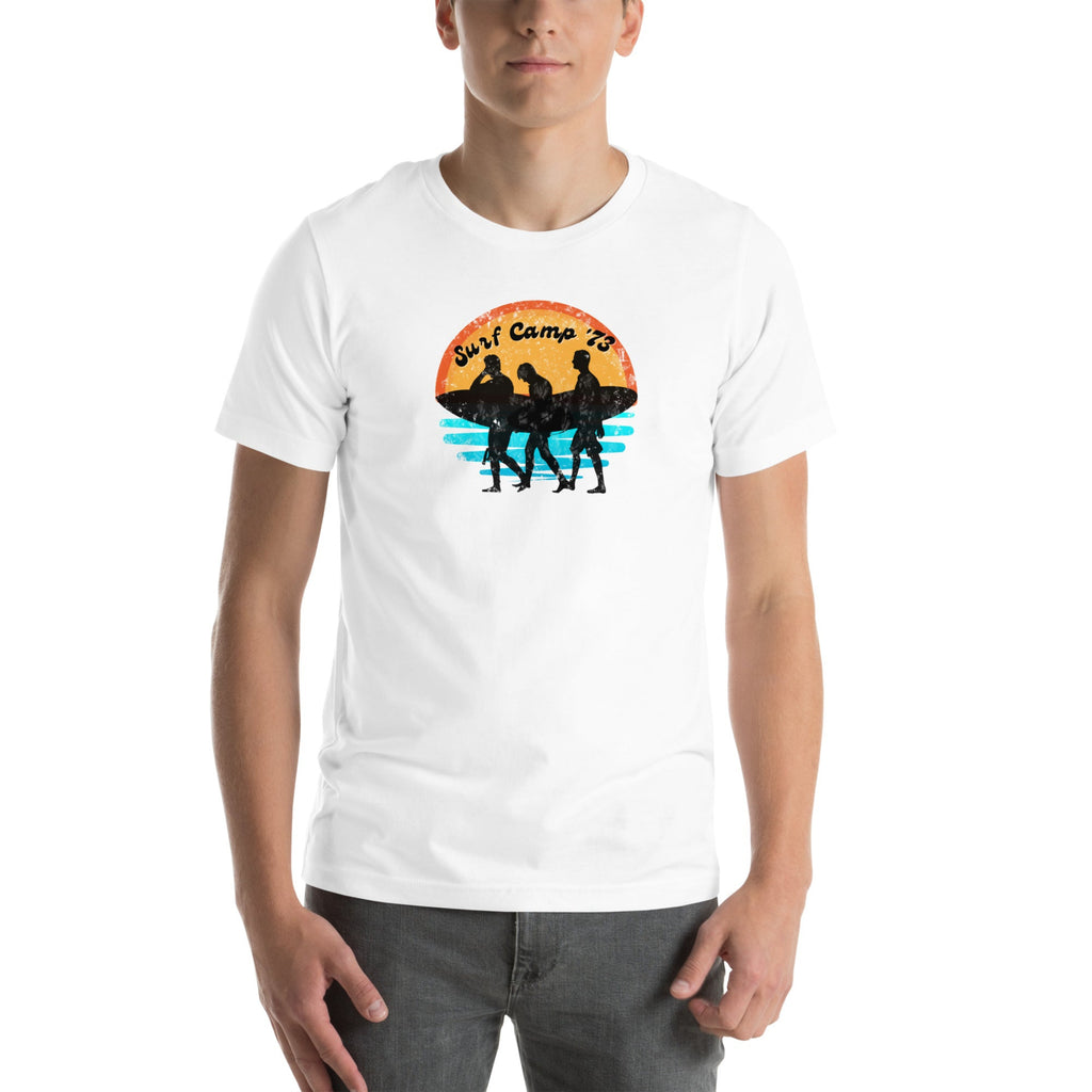 White t-shirt with a graphic design of three silhouettes and text "Surf Camp '73" on a white background.