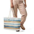Oversized nautical weekender tote bag with blue and tan watercolor stripes and thick cream rope handles