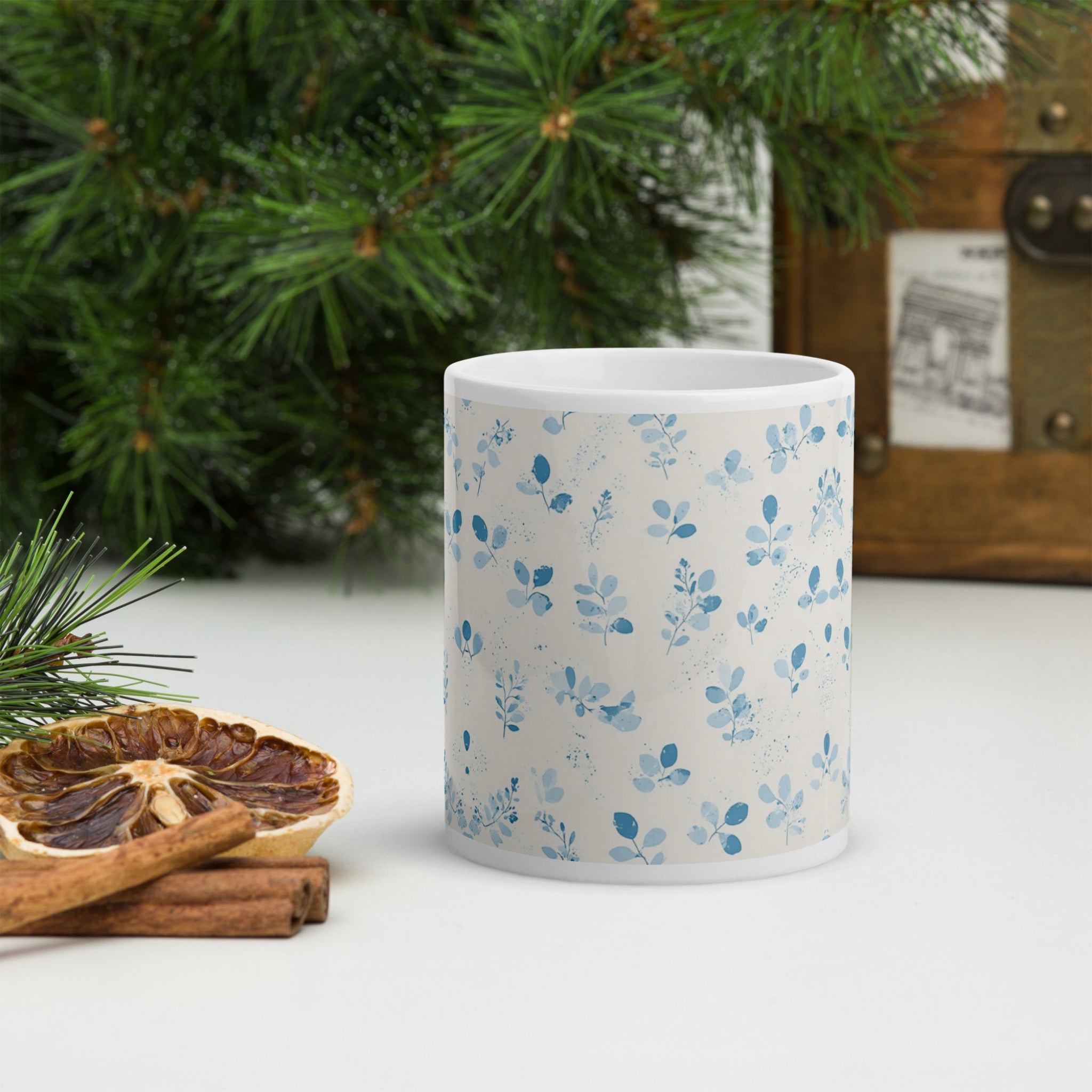  white mug with blue floral patterns 