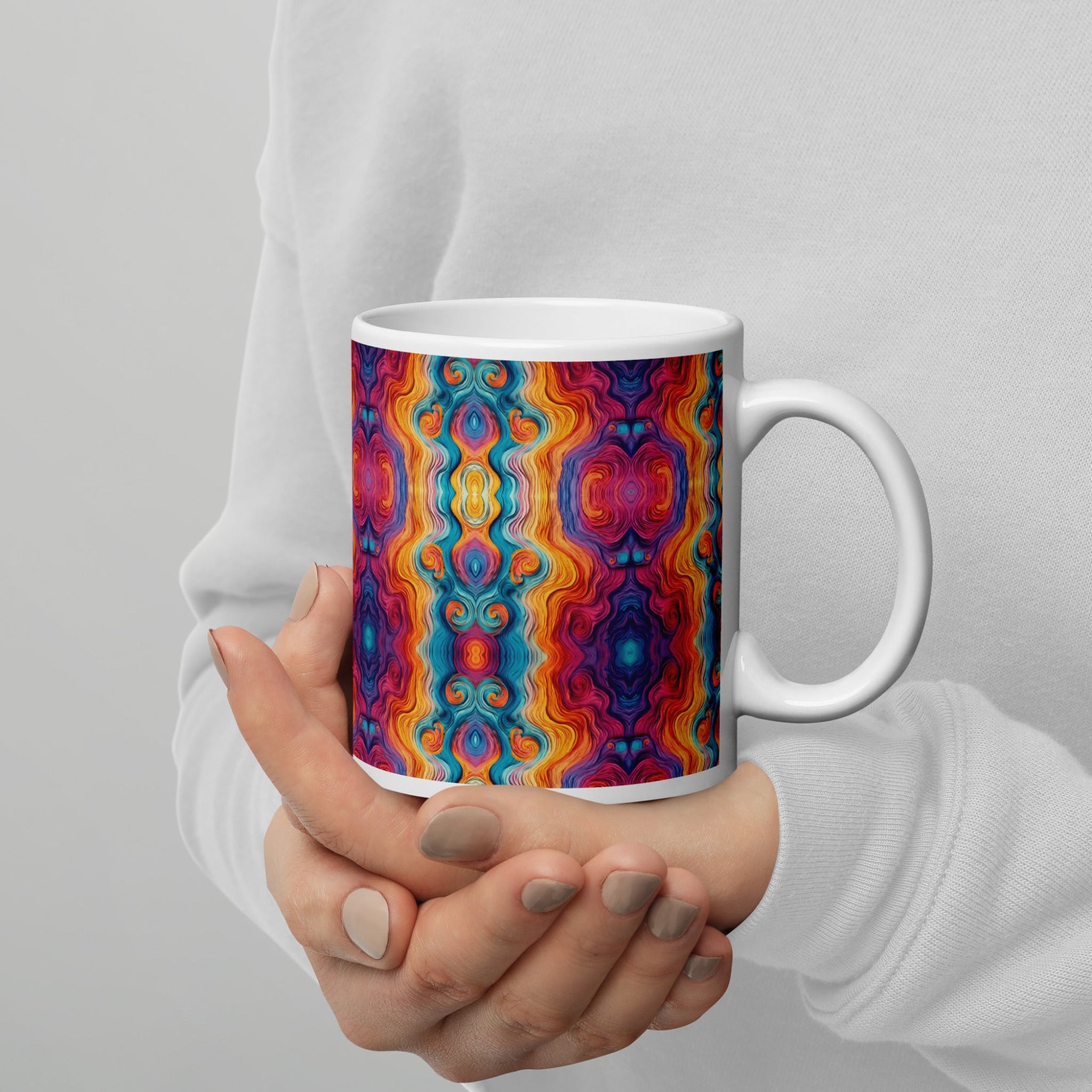 holding a multicolored ceramic coffee mug