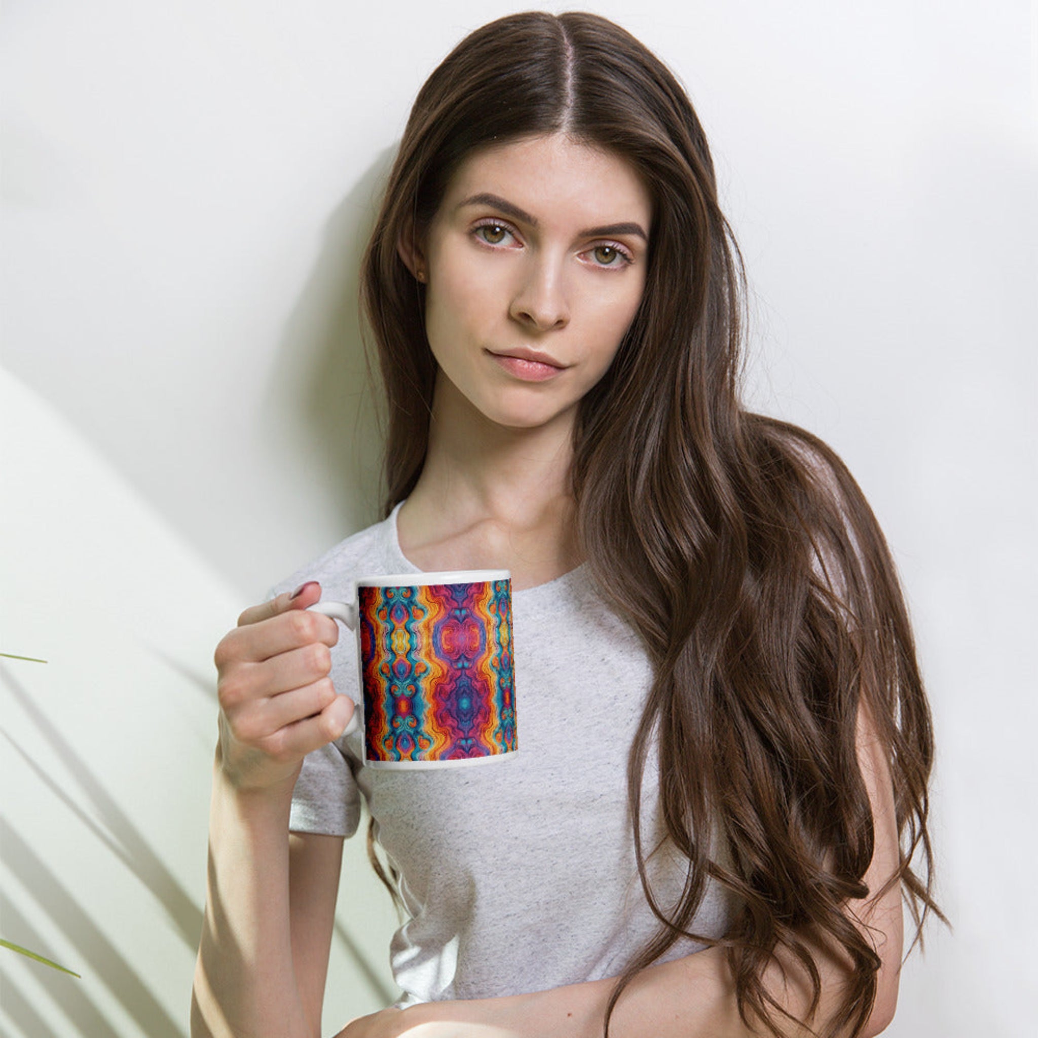 Woman holding a multicolored ceramic coffee mug