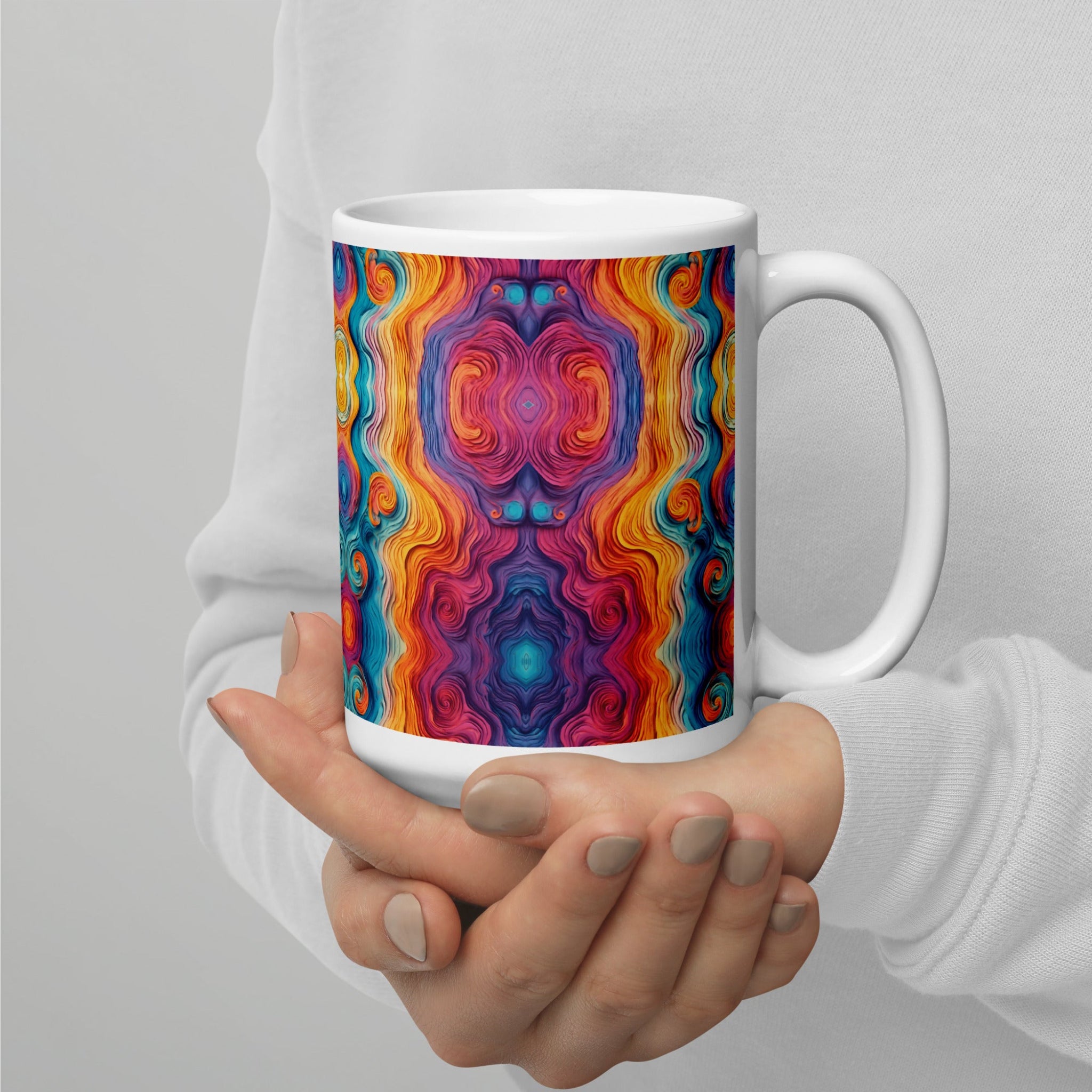 Hands holding a multicolored ceramic coffee mug