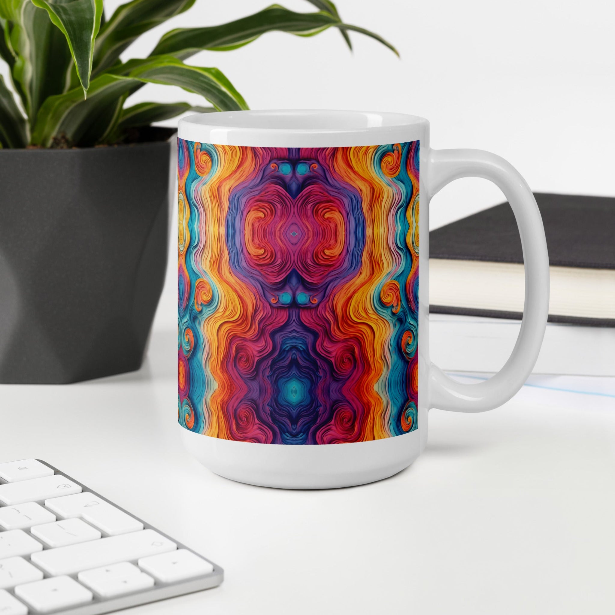 Multicolored Textured look design Coffee Mug. Tea cup on white table next to a potted plant.