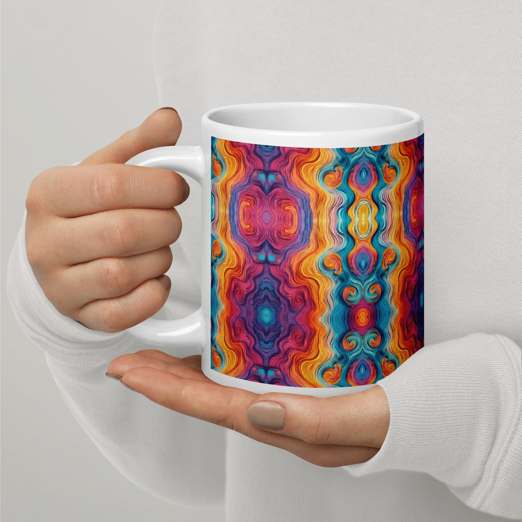 Hands holding a multicolored ceramic coffee mug