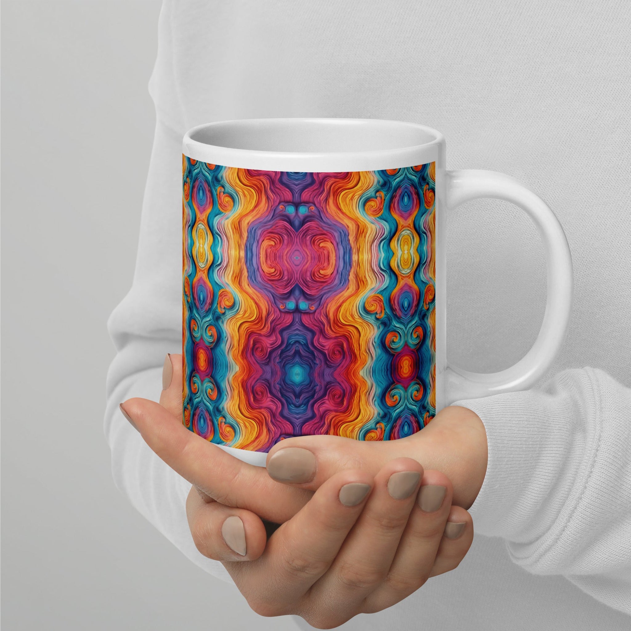 Hands holding a multicolored ceramic coffee mug