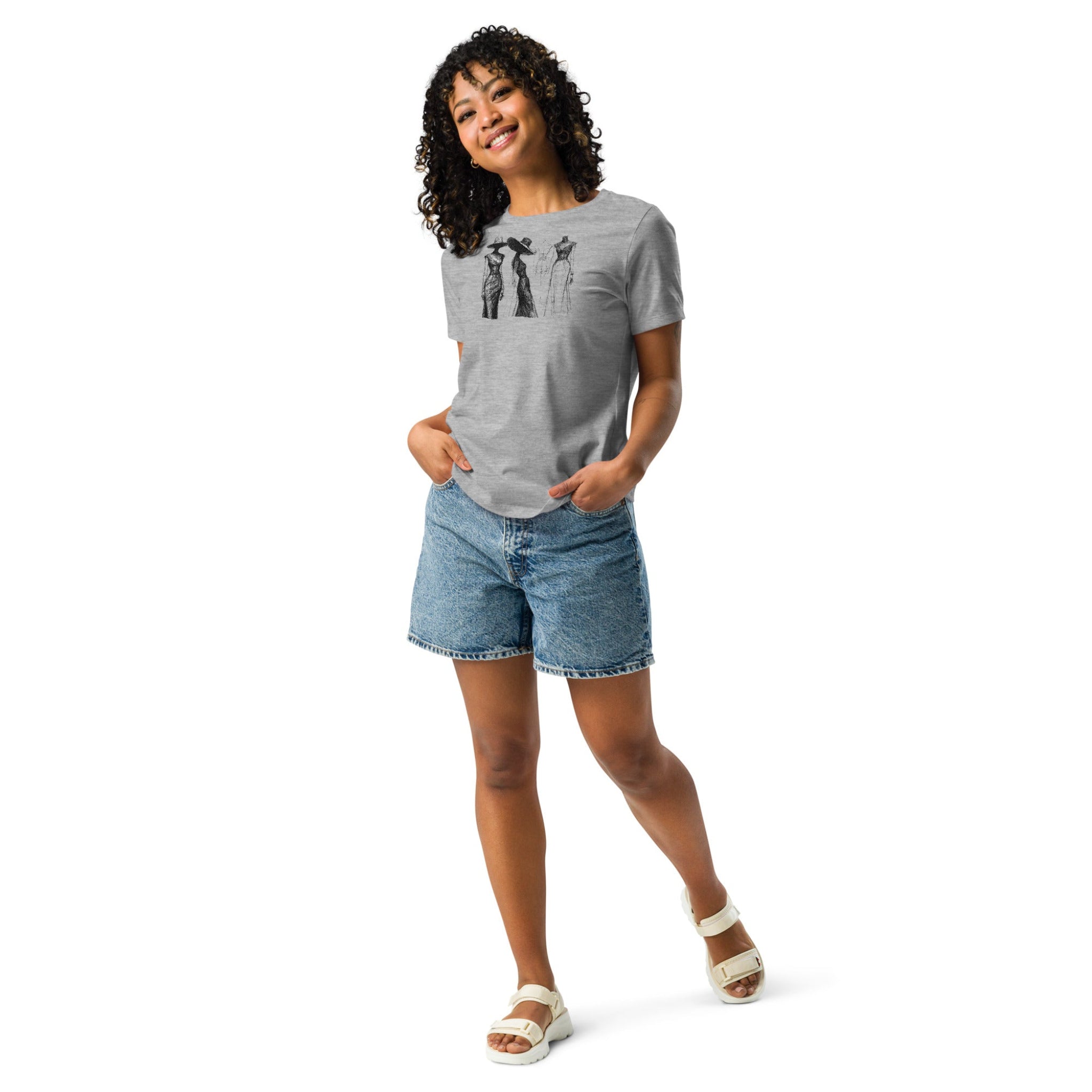 Woman wearing a gray t-shirt with a vintage style fashion sketch design, paired with denim shorts on a white background.
