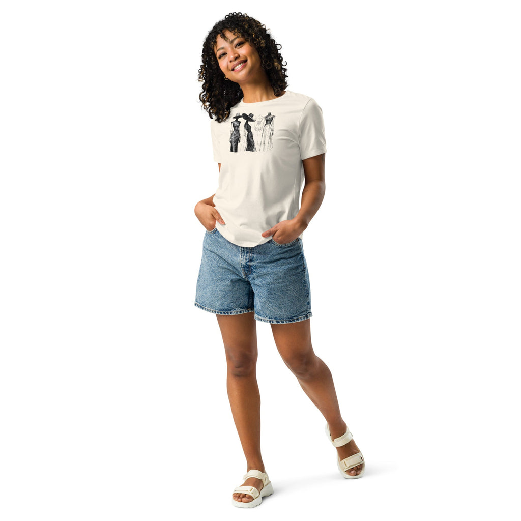 Woman wearing a light tan t-shirt with a vintage style fashion sketch design, paired with denim shorts on a white background.